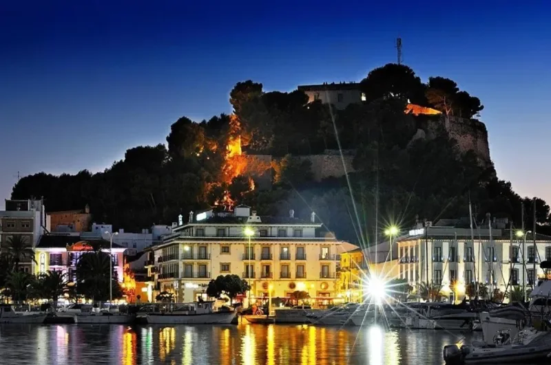 Dénia harbour beneath the illuminated castle